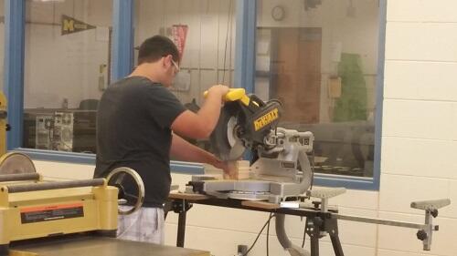 Student using a miter saw